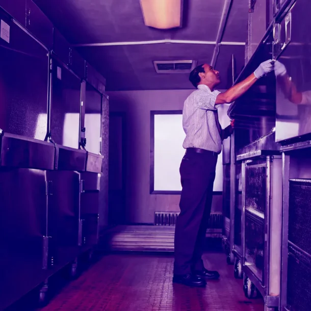 Technician inspecting commercial refrigeration equipment in DFW
