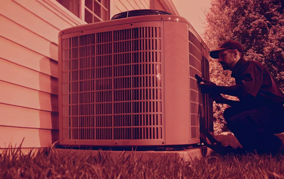 HVAC technician inspecting an outdoor AC unit at a Texas home