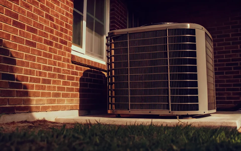 Central air conditioning condenser unit outside a Texas home in summer heat