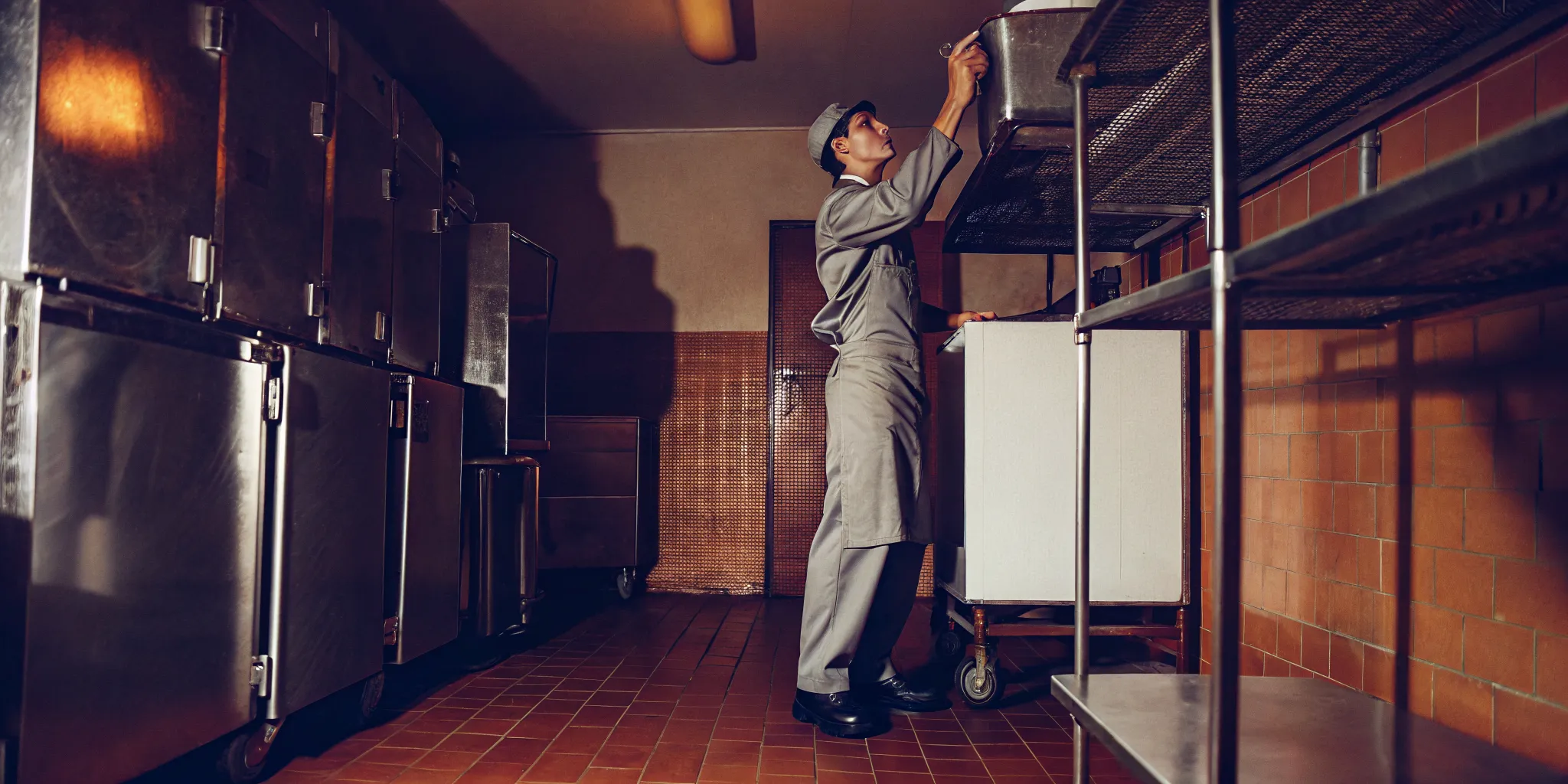 Technician inspecting a commercial walk-in cooler interior